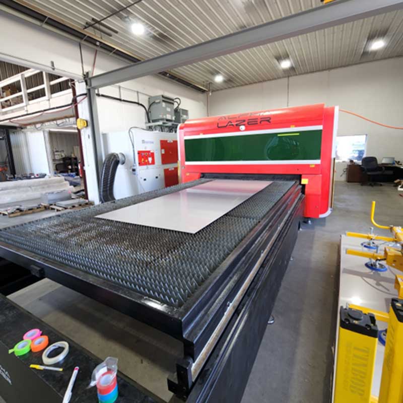 Photo of Sandborn's laser table in action, precisely cutting materials to custom specifications for each internal floating roof system, ensuring a perfect fit for every tank